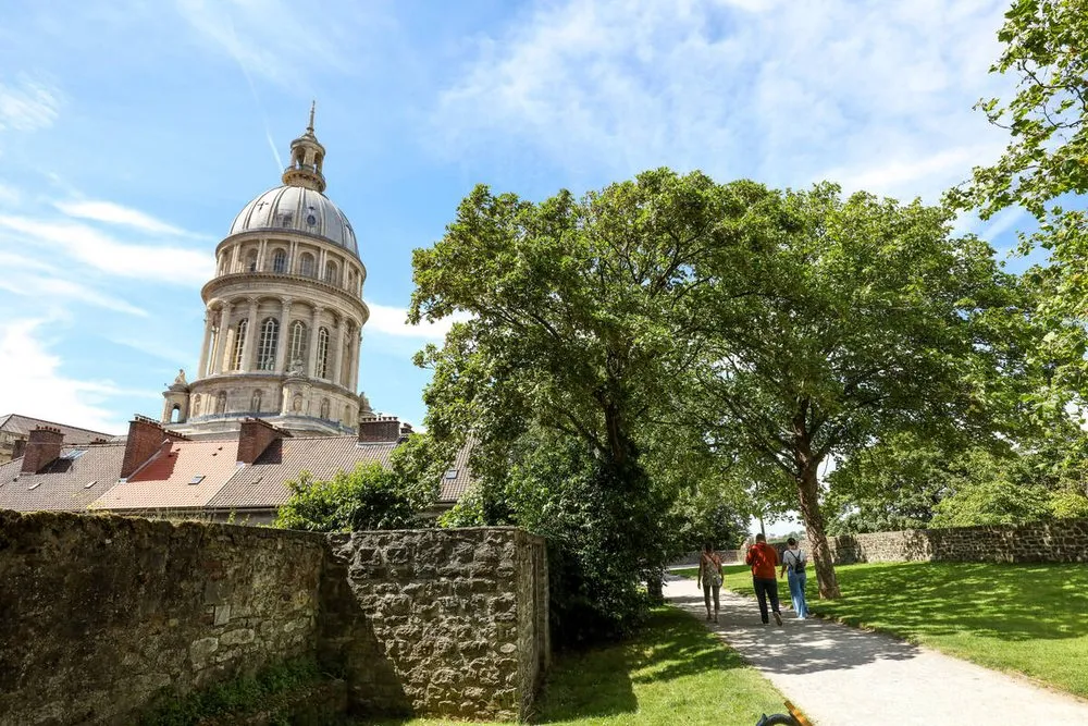 Die Stadtmauer der Oberstadt von Boulogne, die Kuppel der Basilika hinter den Bäumen
